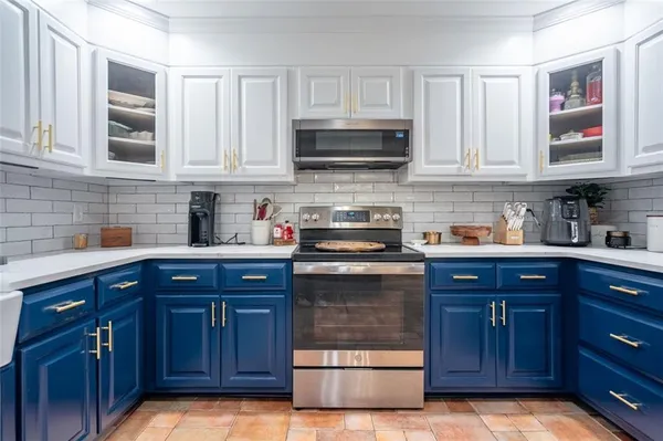 a kitchen with stainless steel appliances granite countertop wooden cabinets and a sink