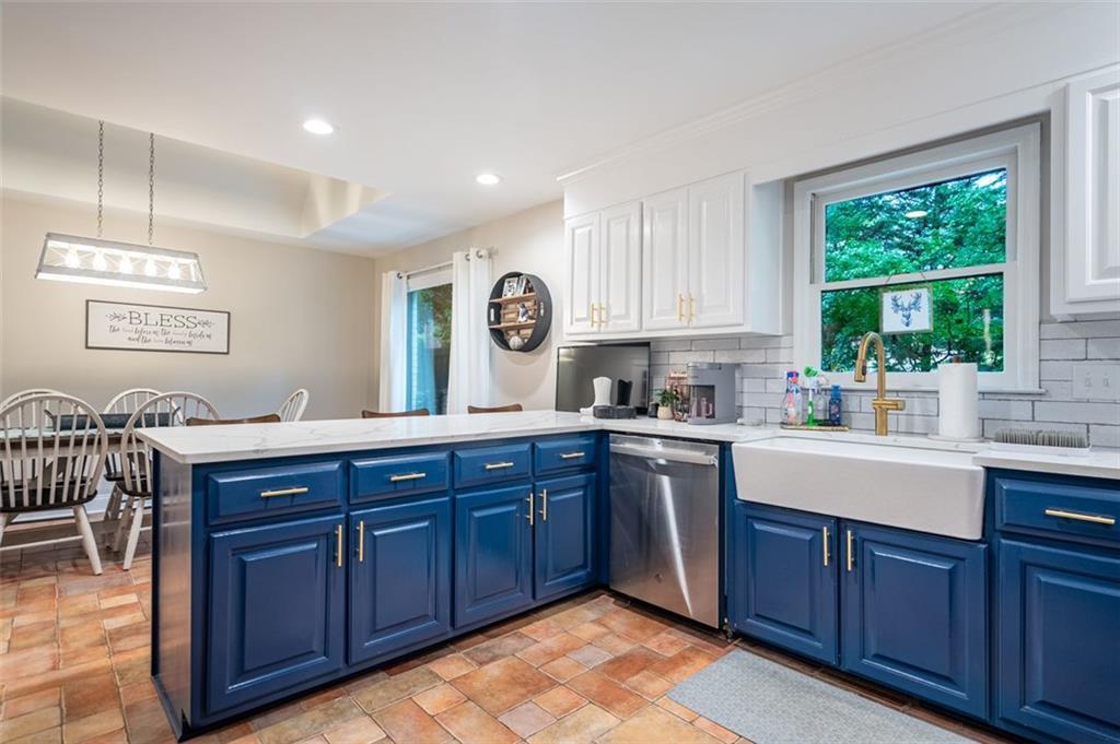 30 Westover Drive Southwest Rome, GA 30165 - Photo 14 of 51 a kitchen with stainless steel appliances granite countertop wooden cabinets a sink and dishwasher with wooden floor