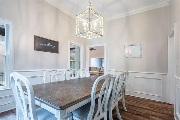 a view of a dining room with furniture and wooden floor