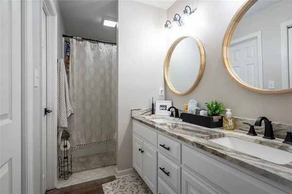 a bathroom with a double vanity sink and a mirror