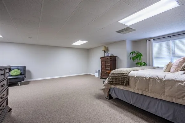 a bedroom with a bed and ceiling fan