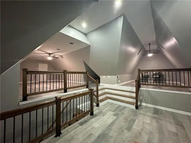 a view of staircase with lots of frames and empty room