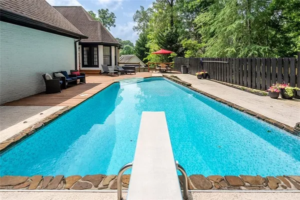 a view of a backyard with a patio and swimming pool