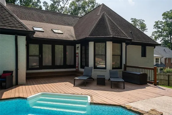 a view of house with yard and sitting area