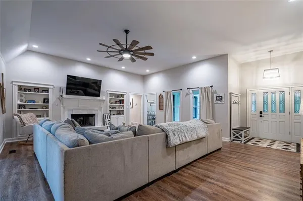 a living room with furniture fireplace and a flat screen tv