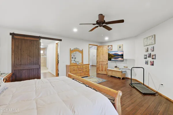 a kitchen with stainless steel appliances granite countertop a refrigerator a stove and a wooden floors