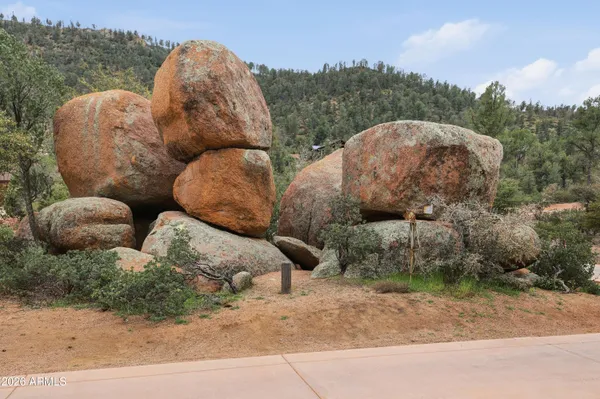 a front view of a house with yard and parking