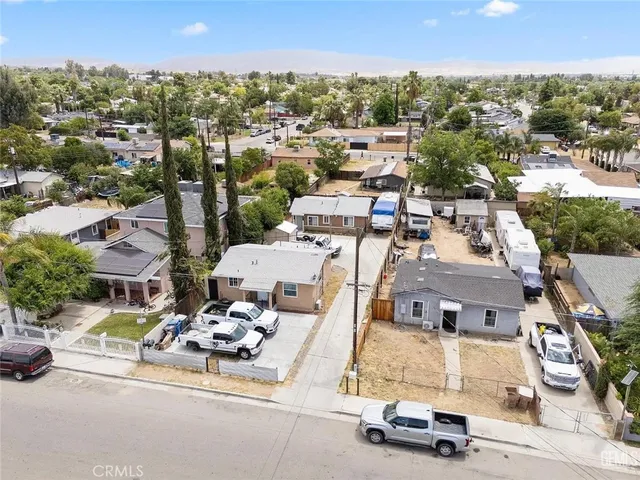 an aerial view of multiple houses with yard