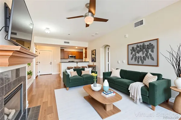 a living room with furniture kitchen view and a fireplace