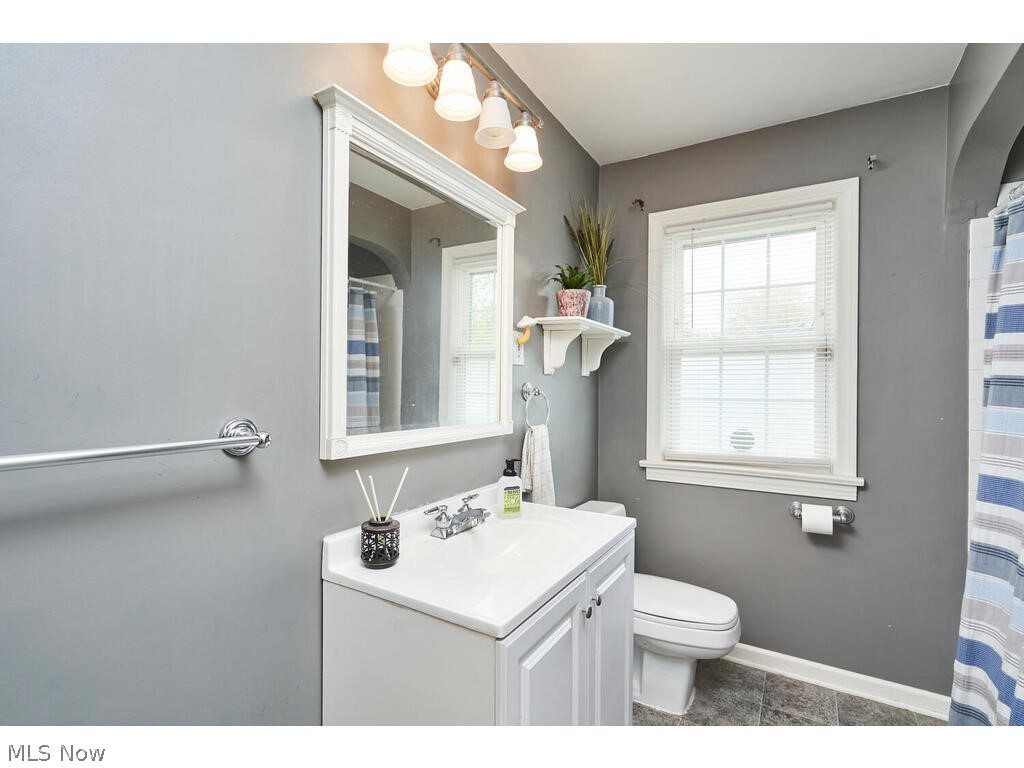 563 East Wilbeth Road Akron, OH 44301 - Photo 10 of 19 Bathroom featuring a wealth of natural light, toilet, tile floors, and vanity