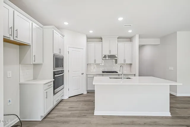 a kitchen that has a sink and a stove