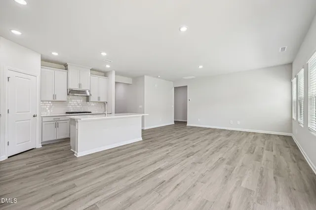 a kitchen with stainless steel appliances a white stove top oven and cabinets