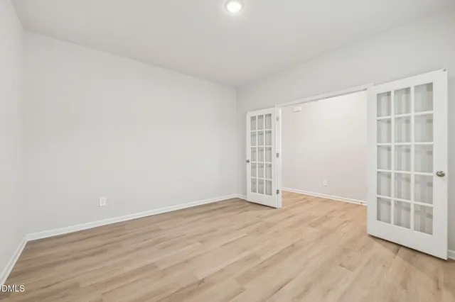 an empty room with a white wall and a window