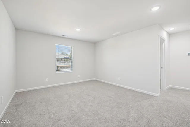 a bathroom with a shower sink vanity mirror and toilet