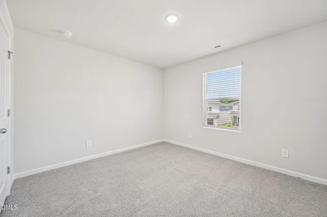 an empty room with a empty space and windows