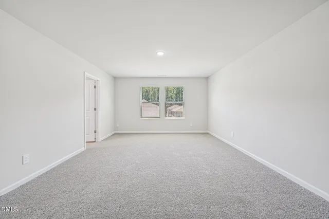 a view of an empty room and a window