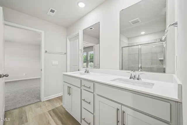 a bathroom with a glass shower door