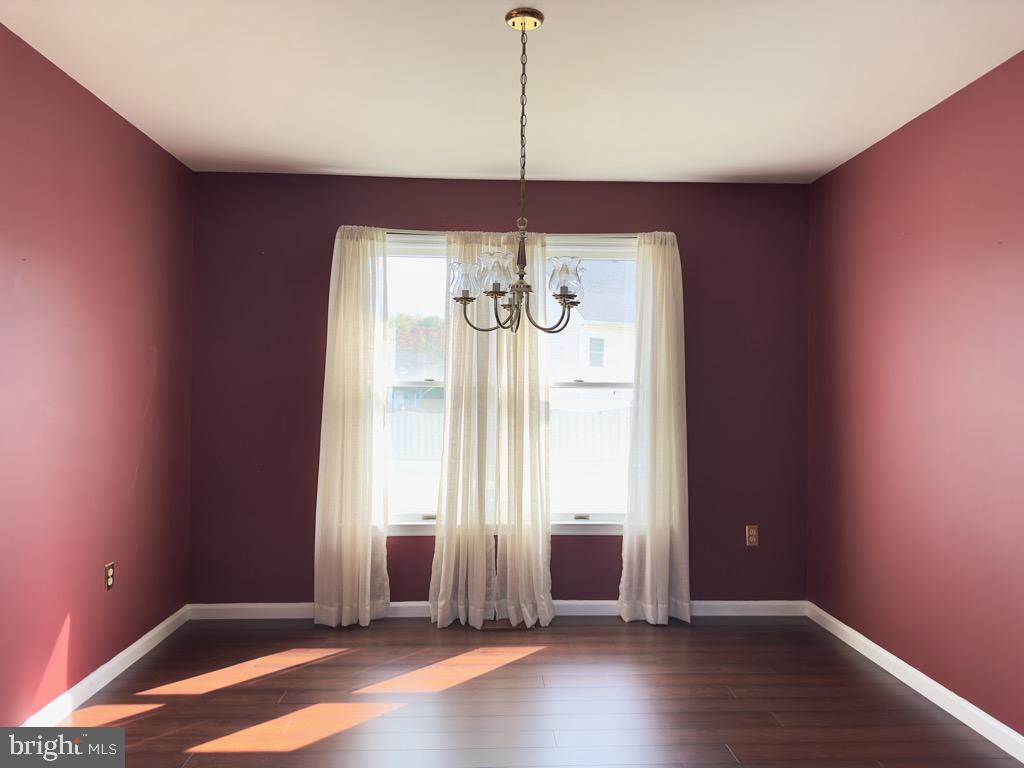 501 Deborah Drive Reading, PA 19608 - Photo 13 of 58 an empty room with wooden floor and windows