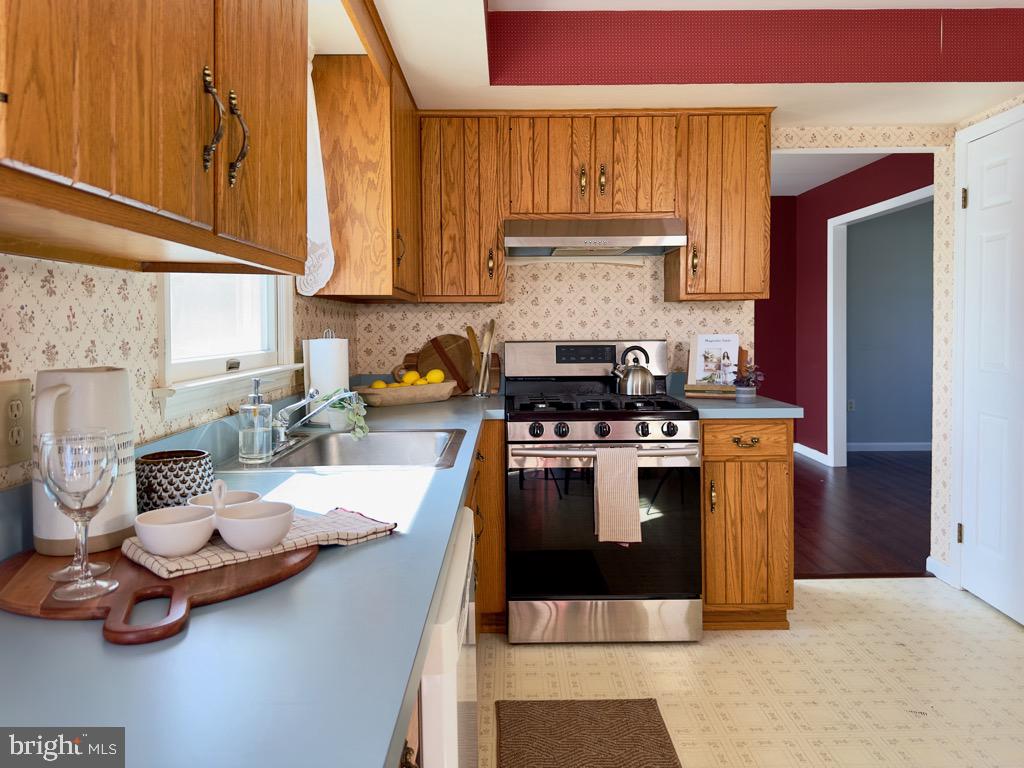 501 Deborah Drive Reading, PA 19608 - Photo 16 of 58 a kitchen with stainless steel appliances a stove a sink and cabinets