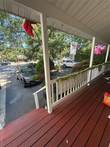 a view of a balcony with wooden floor
