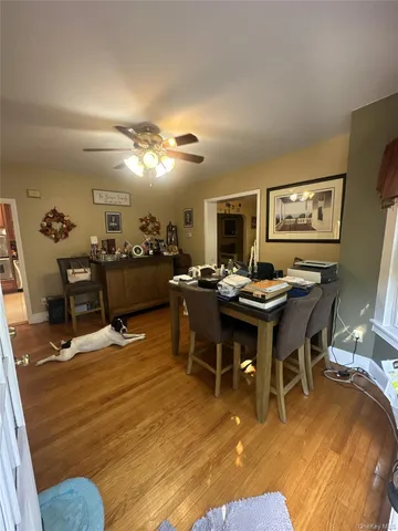 a living room with dining room and kitchen view