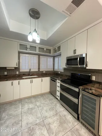 a large kitchen with stainless steel appliances granite countertop a stove and cabinets