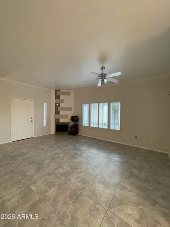 a view of a livingroom with a ceiling fan and window