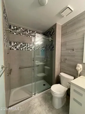 a bathroom with a shower and a toilet