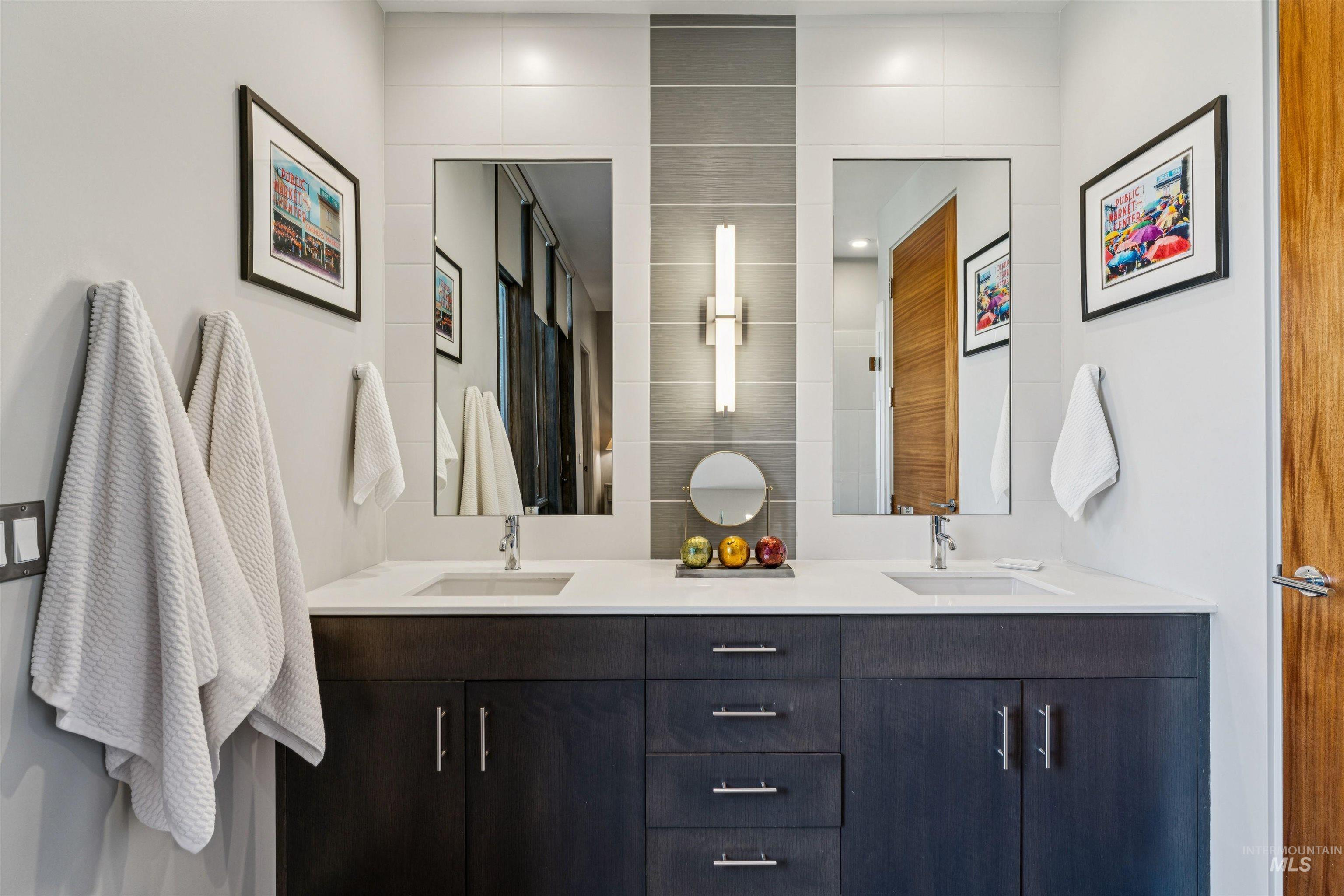 119 South 10th Street, Unit 307 Boise, ID 83702 - Photo 22 of 47 Double vanity featuring a white countertop, dual integrated sinks, and dark wood-finish cabinetry