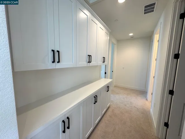 a bathroom with a double vanity sink a mirror and a bathtub