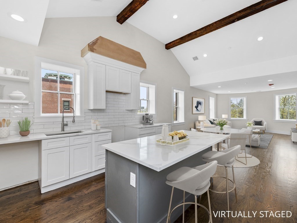a open kitchen with stainless steel appliances granite countertop a sink and dishwasher with wooden floor