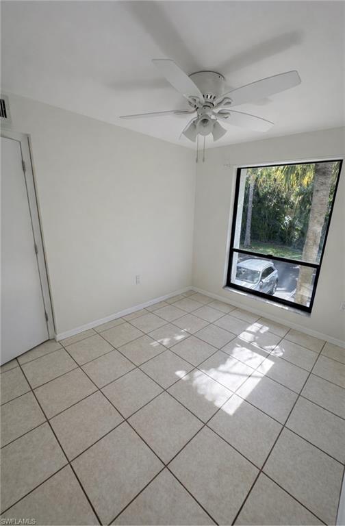 1228 Commonwealth Circle, Unit O203 Naples, FL 34116 - Photo 5 of 17 a view of an empty room with a window
