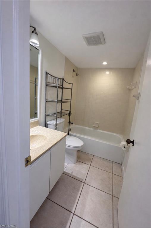1228 Commonwealth Circle, Unit O203 Naples, FL 34116 - Photo 8 of 17 a bathroom with a sink a toilet and shower