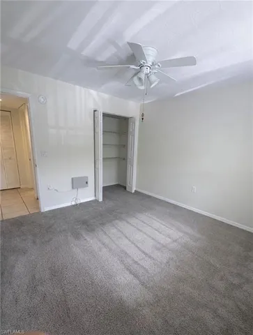 en empty room with windows and fan