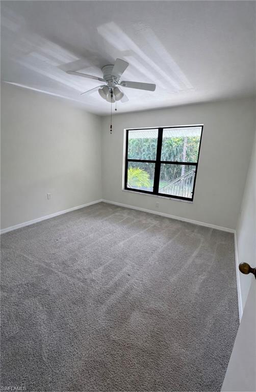 1228 Commonwealth Circle, Unit O203 Naples, FL 34116 - Photo 10 of 17 an empty room with windows and ceiling fan