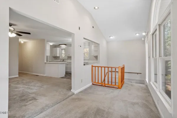 a view of kitchen with windows and ceiling fan