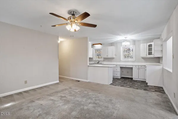 a kitchen with granite countertop a sink cabinets window and stainless steel appliances