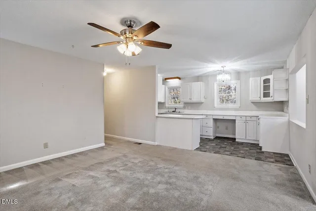 a kitchen with granite countertop a sink cabinets window and stainless steel appliances