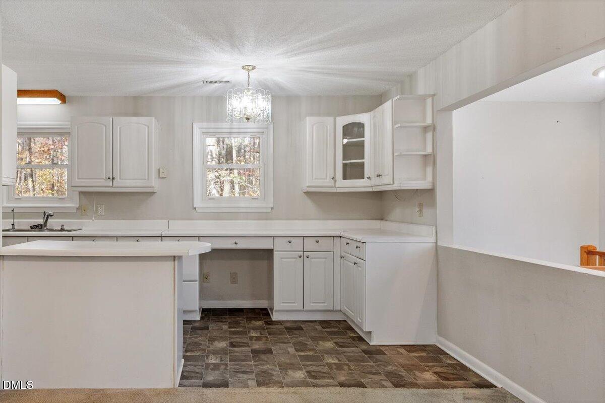 11907 North Roxboro Street Rougemont, NC 27572 - Photo 12 of 37 a kitchen with granite countertop a sink cabinets window and stainless steel appliances