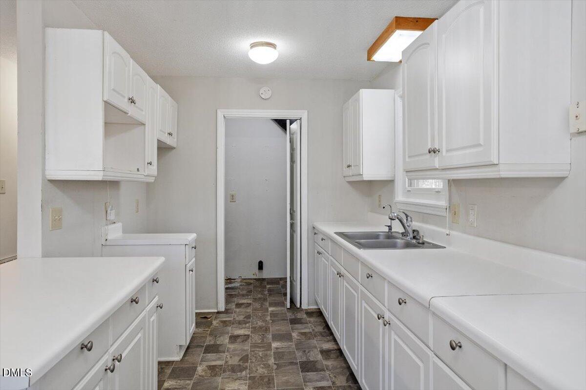 11907 North Roxboro Street Rougemont, NC 27572 - Photo 14 of 37 a kitchen with a sink stove and cabinets