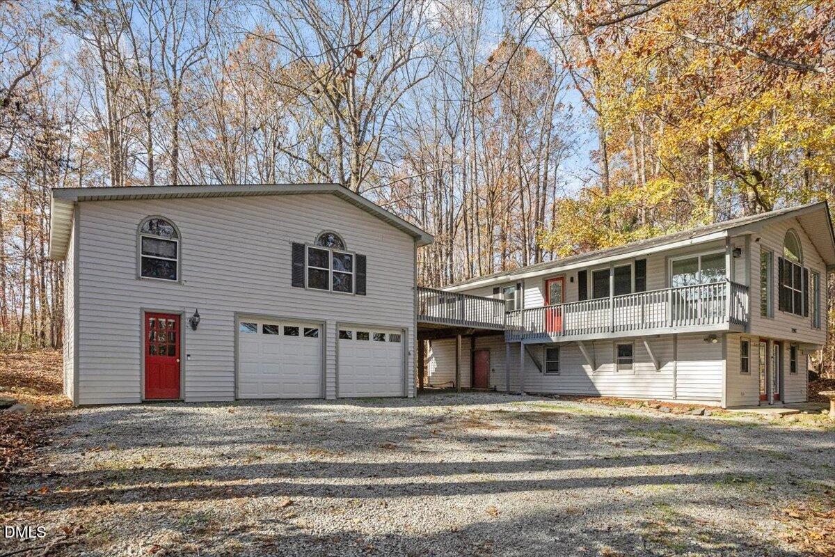 11907 North Roxboro Street Rougemont, NC 27572 - Photo 23 of 37 a front view of a house with a yard and garage