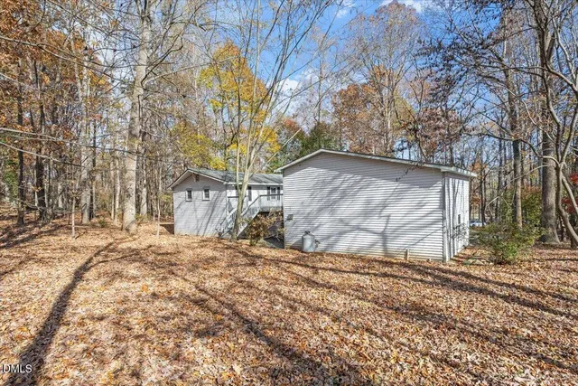 a view of house with deck and wooden floor