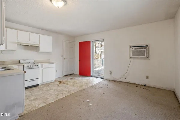 a kitchen with white cabinets and white appliances
