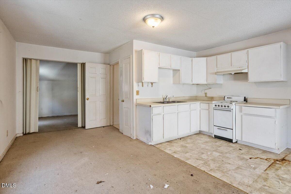 11907 North Roxboro Street Rougemont, NC 27572 - Photo 33 of 37 a kitchen with white cabinets and white appliances
