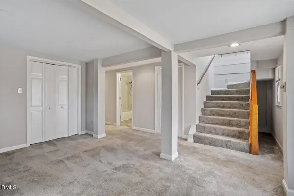 a view of an empty room with stairs