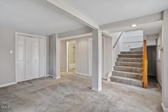 a view of an empty room with stairs