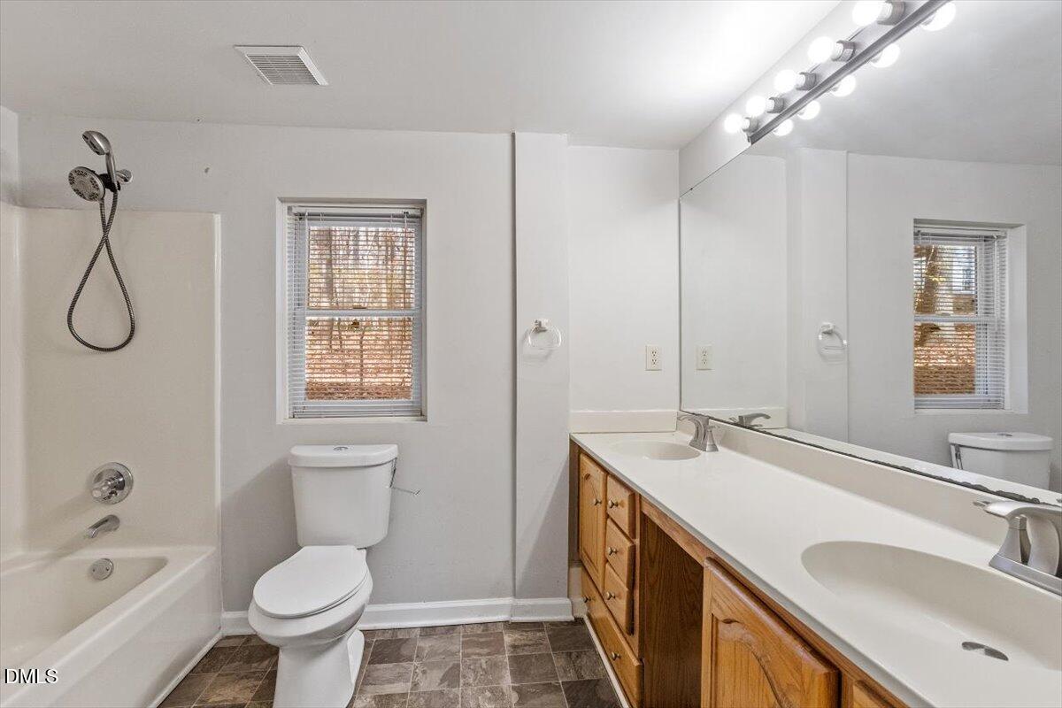 11907 North Roxboro Street Rougemont, NC 27572 - Photo 7 of 37 a bathroom with a granite countertop sink toilet and shower