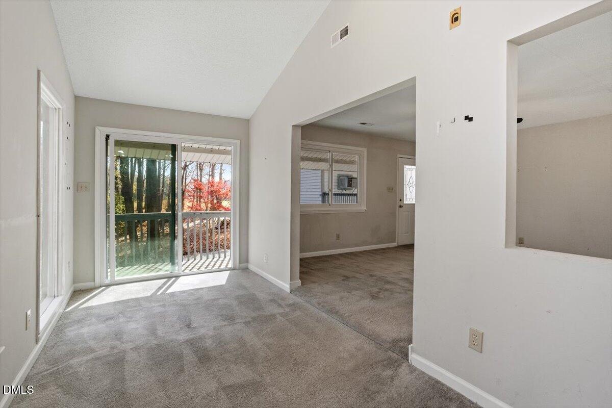 11907 North Roxboro Street Rougemont, NC 27572 - Photo 9 of 37 a view of a hallway with wooden floor and a door