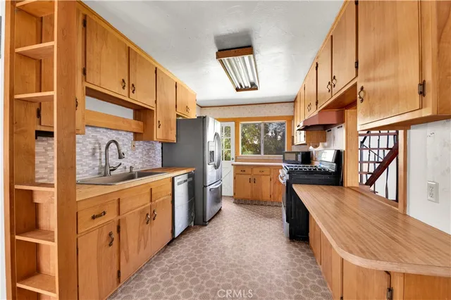 a kitchen with stainless steel appliances kitchen island granite countertop a sink and cabinets
