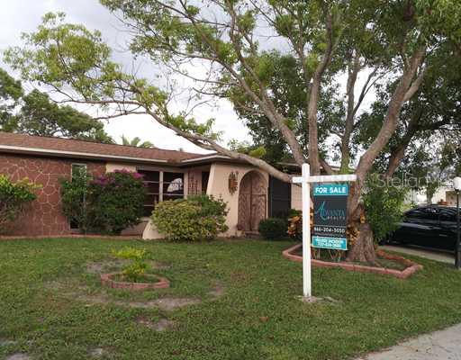 9140 Chatam Lane Port Richey, FL 34668 - Photo 1 of 1 Exterior Front - Mature landscaping compliments the front exterior of the home.